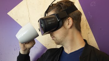 Man Wearing Virtual Reality Headset And Holding A Mug