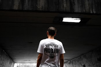 Man Wearing White and Black Burn Your Problems Printed T-shirt
