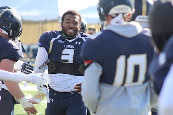 Man Wearing White And Blue Under Armour Football Jersey