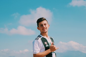 Man Wearing White and Green Adidas V-neck Jersey Shirt Smiling
