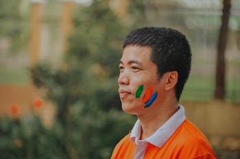 Man Wearing White and Orange Polo Shirt