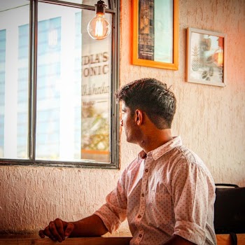 Man Wearing White and Red Dress Shirt Staring Outside Window