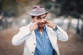 Man Wearing White Blazer With Hands on Cheeks