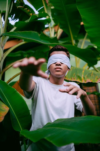 Man Wearing White Blindfold