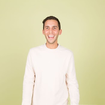 man wearing white crew-neck long-sleeved shirt standing inside well lighted room