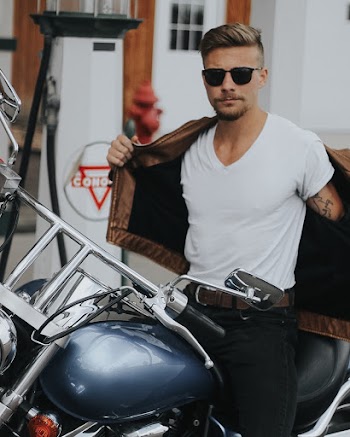 Man Wearing White Crew-neck T-shirt Sitting on Motorbike