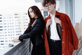 Man Wearing White Dress Shirt Besides Woman Wearing Black Coat