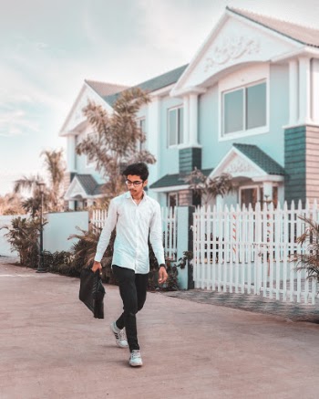 Man Wearing White Dress Shirt Walks On The Street
