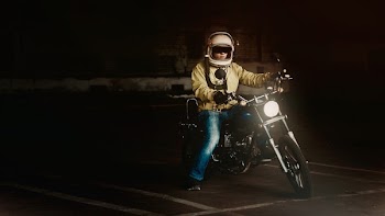 Man Wearing White Full Face Helmet Riding on Standard Motorcycle