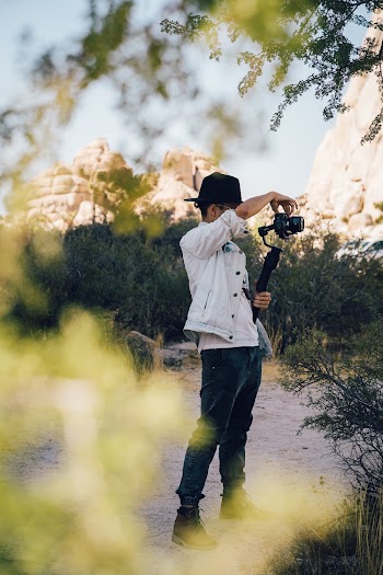 Man Wearing White Jacket Holding Camera