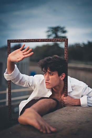 Man Wearing White Long-sleeved Dress Shirt Holding Frame