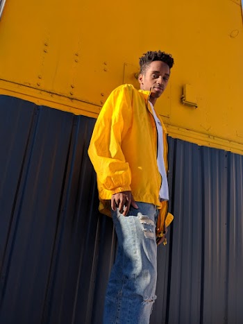 Man Wearing White Shirt And Yellow Zip Jacket And Blue Denim Jeans 