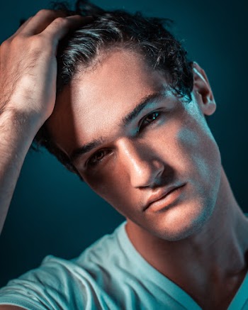 Man Wearing White Shirt Holding His Hair