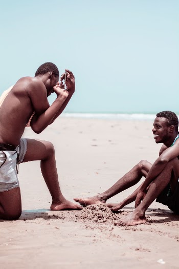 Man Wearing White Shorts on Sand