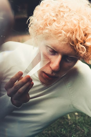 Man Wearing White Top Holding White Glass