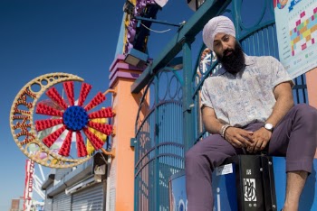 Man Wearing White Turban and Gray Polo Shirt 