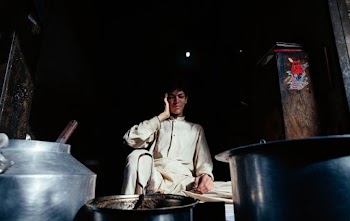 Man Wearing White Uniform in Front of Stainless Steel Pot