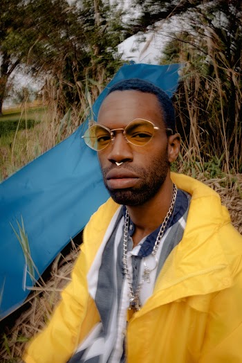 Man Wearing Yellow Jacket And Yellow Round Sunglasses Frames