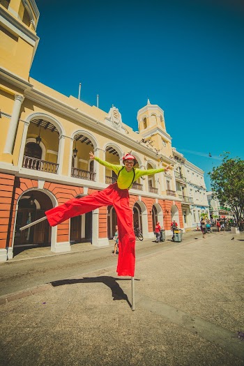 Man Wearing Yellow Long-sleeved Shirt and Red Pants Under Clear Blue Sky