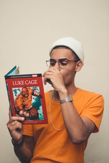 Man Wearing Yellow Shirt Reading Luke Cage Book