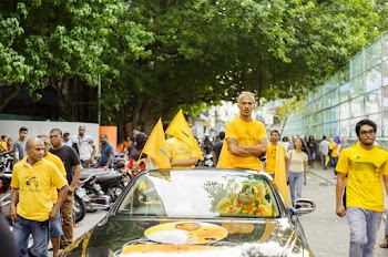 Man Wearing Yellow Shirt Walking on Street
