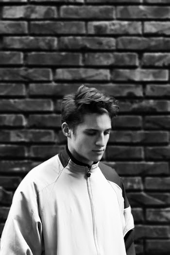 Man Wearing Zip-up Jacket With Brick Wall Background