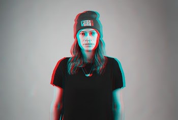 man wears black crew-neck t-shirt and gray knitted cap