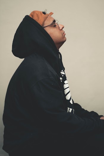 Man Wears Black Hoodie and Reverse Brown Cap