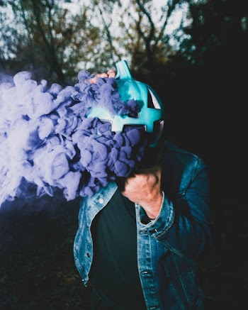 Man Wears Blue Jacket Smoking