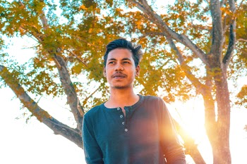 Man Wears Half-button Sweater Near Green Tree