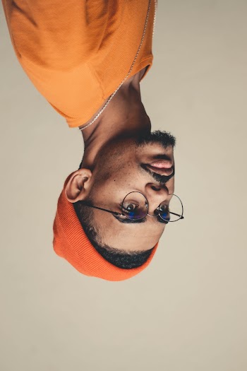 Man Wears Orange Knit Cap and Shirt