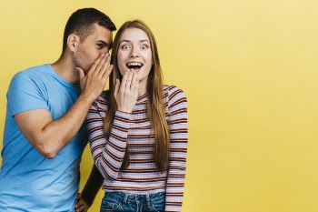 Man whispering to his best friend Free Photo