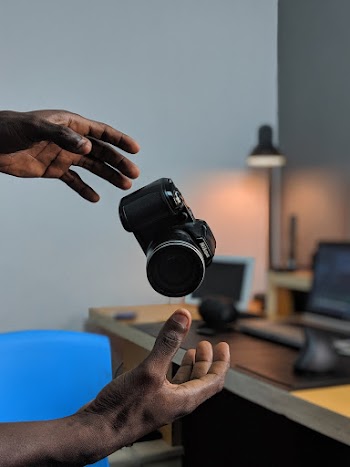 Man With a Black and Gray Nikon Dlsr Camera
