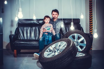 Man With a Boy Sitting on Sofa