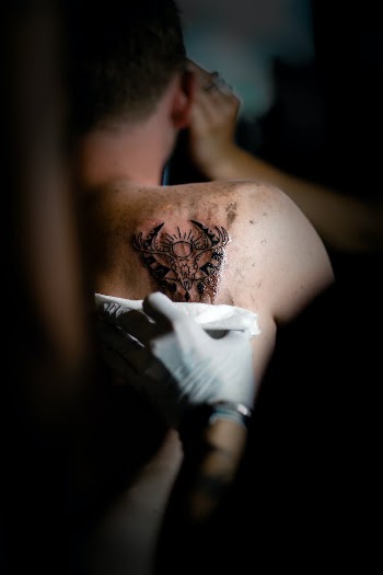 Man With Black Tattoo on His Back