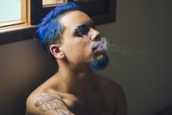 Man With Blue Hair Smoking Near The Window