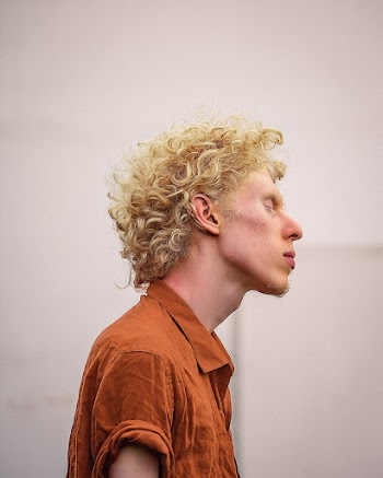 Man With Closed Eyes in Collared Shirt
