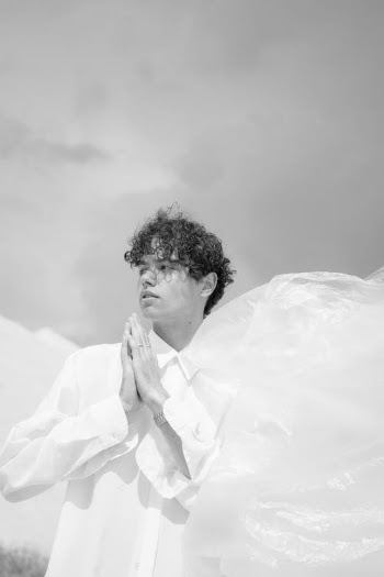 Man with Curly Hair and in White Shirt · Free Stock Photo