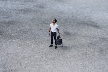Man With Duffle Looks Up