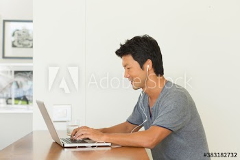 Man with headphones and laptop working from home