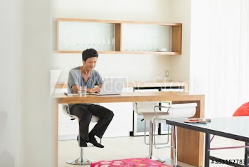 Man with headphones working form home at laptop