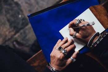 Man With Rings Writing