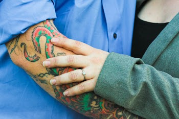 Man With Tattoo With a Woman in Green Top