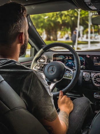 Man with Tattoos  Driving a Car