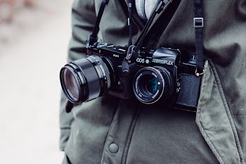 Man with two cameras over his neck