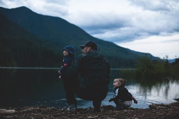 Man With Two Kids Near Body of Water