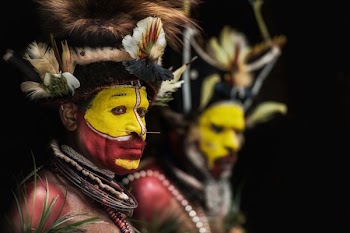man with yellow and red face paints