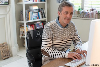 Man working at computer in home office