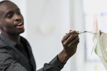 Man Writes On Whiteboard