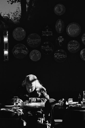 Man Writing on Desk Grayscale Photography